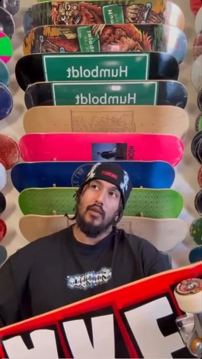 Al Bear in front of a wall of skate decks, two of them reading Humboldt